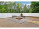 Backyard fire pit with benches and a white fence offers a private outdoor space at 2631 Young Rd, Stone Mountain, GA 30088