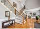 Elegant foyer showcasing a grand staircase with decorative wrought iron spindles and hardwood floors at 2631 Young Rd, Stone Mountain, GA 30088