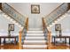 Elegant foyer showcasing a grand staircase with decorative wrought iron spindles and hardwood floors at 2631 Young Rd, Stone Mountain, GA 30088