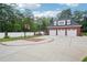 Spacious three-car garage with basketball hoop on driveway, perfect for recreation and vehicle storage at 2631 Young Rd, Stone Mountain, GA 30088