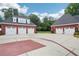 Spacious three-car garage with brick exterior and ample driveway space for parking and outdoor activities at 2631 Young Rd, Stone Mountain, GA 30088