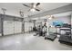 Garage converted gym with multiple exercise machines and ceiling fans at 2631 Young Rd, Stone Mountain, GA 30088