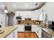 Well-lit kitchen features granite countertops, stainless steel appliances, and white cabinetry at 2631 Young Rd, Stone Mountain, GA 30088