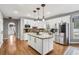 Spacious kitchen with stainless steel refrigerator, granite island, and modern lighting at 2631 Young Rd, Stone Mountain, GA 30088