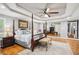 Large main bedroom with a four-poster bed, sitting area, and tray ceiling at 2631 Young Rd, Stone Mountain, GA 30088
