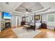 Main bedroom features a fireplace, ceiling fan, sitting area, and a four-poster bed at 2631 Young Rd, Stone Mountain, GA 30088