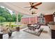 Outdoor patio with ceiling fans, TV, grill, table and chairs, overlooking backyard at 2631 Young Rd, Stone Mountain, GA 30088
