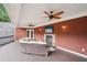 Cozy outdoor porch area with fireplace, TV, comfortable seating, and ceiling fans for relaxation and entertaining at 2631 Young Rd, Stone Mountain, GA 30088