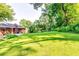Expansive backyard featuring lush green lawn and mature trees, perfect for outdoor activities at 516 Jordan Nw Dr, Tucker, GA 30084
