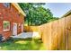 Fenced backyard with small concrete patio and grassy area, offering privacy and outdoor space at 516 Jordan Nw Dr, Tucker, GA 30084