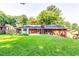 View of the backyard with lawn and brick home at 516 Jordan Nw Dr, Tucker, GA 30084