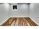 View of the finished basement with wood flooring and a small window at 516 Jordan Nw Dr, Tucker, GA 30084