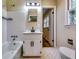 This bathroom features a tub/shower, cabinet sink, black hardware, and white tile at 516 Jordan Nw Dr, Tucker, GA 30084