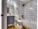 Bathroom with marble-style tiles, modern vanity, and dark fixtures at 516 Jordan Nw Dr, Tucker, GA 30084