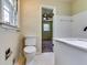 This bathroom features a white sink, toilet, and tile flooring at 516 Jordan Nw Dr, Tucker, GA 30084