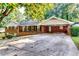 Charming brick home features a covered carport and an expansive driveway at 516 Jordan Nw Dr, Tucker, GA 30084