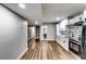 Basement kitchen with wooden flooring, mosaic backsplash, and stainless steel appliances at 516 Jordan Nw Dr, Tucker, GA 30084