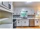 This kitchen features white cabinets, stainless steel appliances, and a modern backsplash at 516 Jordan Nw Dr, Tucker, GA 30084
