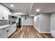View of a basement kitchen with hardwood flooring, white cabinets, and stainless appliances at 516 Jordan Nw Dr, Tucker, GA 30084