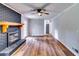 The large living room has a black brick fireplace with wood mantle, hardwood floors, and a view to the kitchen at 516 Jordan Nw Dr, Tucker, GA 30084
