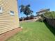 Spacious backyard featuring a retaining wall, healthy lawn, and mature tree offering natural beauty at 5290 Hidden Valley Ln, Cumming, GA 30028