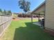 Backyard with a green lawn, wood fence, and covered patio perfect for outdoor relaxation and entertainment at 5290 Hidden Valley Ln, Cumming, GA 30028