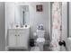 Clean bathroom with a single sink vanity, toilet, and shower/tub combination at 5290 Hidden Valley Ln, Cumming, GA 30028