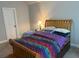 Bedroom with wooden bedframe, colorful striped bedspread, and carpeted floors at 5290 Hidden Valley Ln, Cumming, GA 30028
