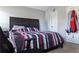 Bedroom with dark wood headboard, striped bedspread, and neutral walls at 5290 Hidden Valley Ln, Cumming, GA 30028