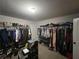 Large walk-in closet with ample hanging space and shelving for clothes and accessories at 5290 Hidden Valley Ln, Cumming, GA 30028