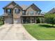 Beautiful two-story brick home with a well-manicured lawn and a two-car garage at 5290 Hidden Valley Ln, Cumming, GA 30028