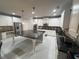 Modern kitchen featuring white cabinets, a large center island, and stainless steel appliances at 5290 Hidden Valley Ln, Cumming, GA 30028