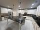 Modern kitchen featuring white cabinets, a large center island, and stainless steel appliances at 5290 Hidden Valley Ln, Cumming, GA 30028