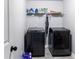 Laundry room featuring modern washer and dryer, shelving, and gray walls at 5290 Hidden Valley Ln, Cumming, GA 30028
