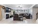 Spacious living room with a fireplace, a large tv, and stylish seating arrangements at 5290 Hidden Valley Ln, Cumming, GA 30028