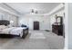 Spacious primary bedroom features tray ceiling, neutral color palette, carpet, and ceiling fan at 5290 Hidden Valley Ln, Cumming, GA 30028