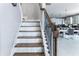 Elegant staircase with dark wood treads, white risers, and ornate iron railings at 5290 Hidden Valley Ln, Cumming, GA 30028