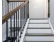 Elegant staircase with dark wood treads, white risers, and ornate iron railings at 5290 Hidden Valley Ln, Cumming, GA 30028