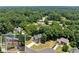 Aerial view of home surrounded by mature trees and lush landscaping at 1520 Dorchester Dr, Lawrenceville, GA 30043