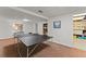 Basement featuring a ping pong table, with carpeted floors and a door to the storage room at 1520 Dorchester Dr, Lawrenceville, GA 30043