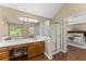 Bright bathroom with a shower, double vanity sink, and a view to the bedroom at 1520 Dorchester Dr, Lawrenceville, GA 30043
