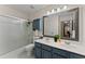 Bathroom featuring a double vanity sink, large mirror, a shower, and a toilet at 1520 Dorchester Dr, Lawrenceville, GA 30043