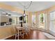 Inviting breakfast nook with wood floors, pendant lighting, and views to the living room and backyard at 1520 Dorchester Dr, Lawrenceville, GA 30043