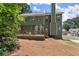 Exterior view of home featuring a back deck, lush landscaping, and well-maintained lawn at 1520 Dorchester Dr, Lawrenceville, GA 30043