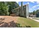 Exterior view of home featuring a back deck, lush landscaping, and well-maintained lawn at 1520 Dorchester Dr, Lawrenceville, GA 30043