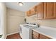 Functional laundry room with washer, dryer, and ample storage at 1520 Dorchester Dr, Lawrenceville, GA 30043