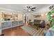 Open living room with wood floors, neutral decor, and views to the kitchen and front entryway at 1520 Dorchester Dr, Lawrenceville, GA 30043