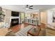 Open concept living room featuring wood floors, fireplace, and views to kitchen at 1520 Dorchester Dr, Lawrenceville, GA 30043