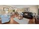 Open-concept living room and dining area with hardwood floors and abundant natural light at 1520 Dorchester Dr, Lawrenceville, GA 30043