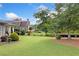 Expansive backyard featuring lush green grass, mature trees, and meticulous landscaping for outdoor enjoyment at 4875 Churchill Ridge Dr, Cumming, GA 30028